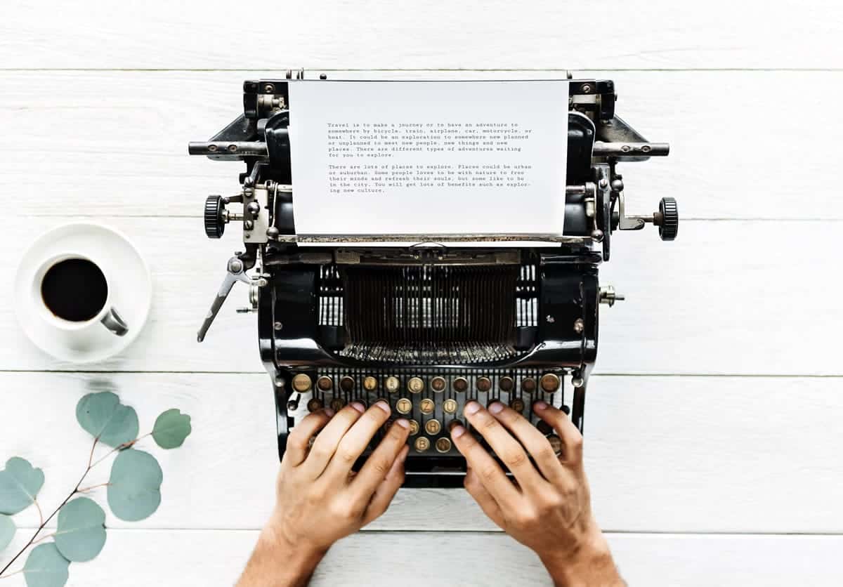 Image of a person typing on a typewriter