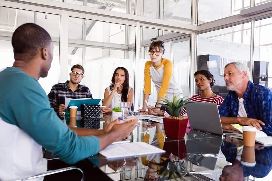 A photo of a workgroup having a meeting about their latest mobile app prototype.