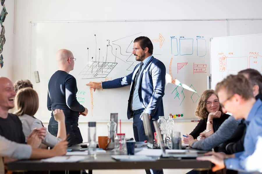 A photo of a team leader discussing a design idea during a design sprint.