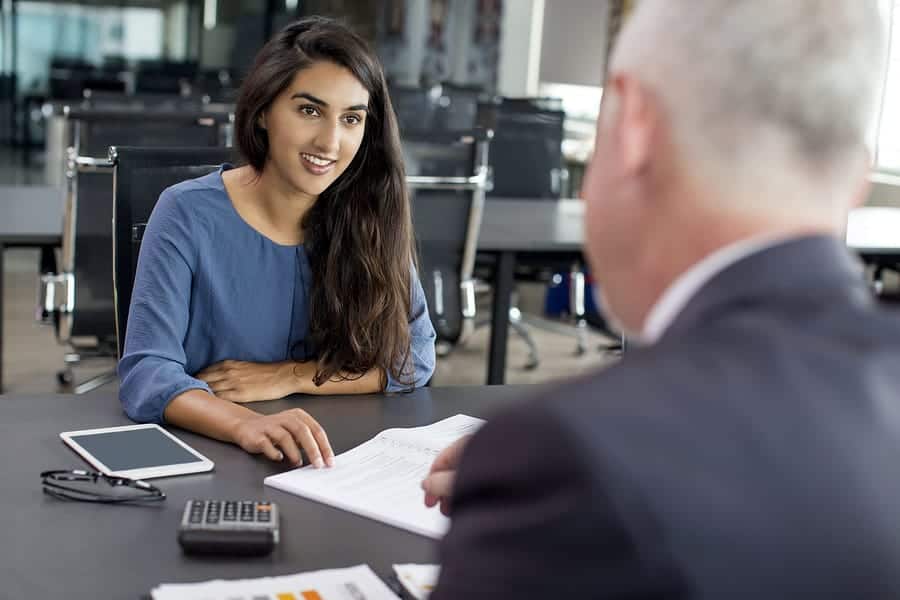 A photo of a woman having a one-on-one meeting with a man.