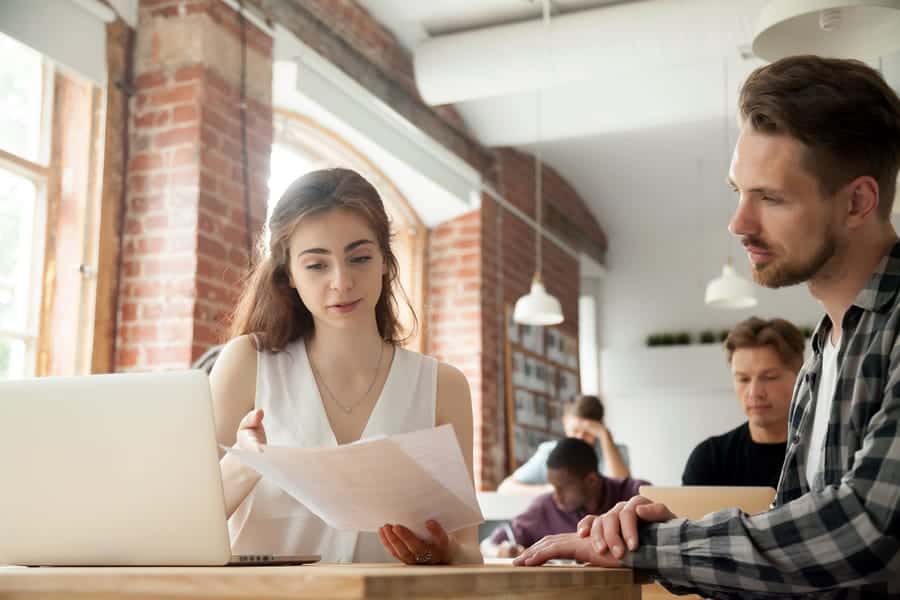 A photo of two product management team members reviewing data.