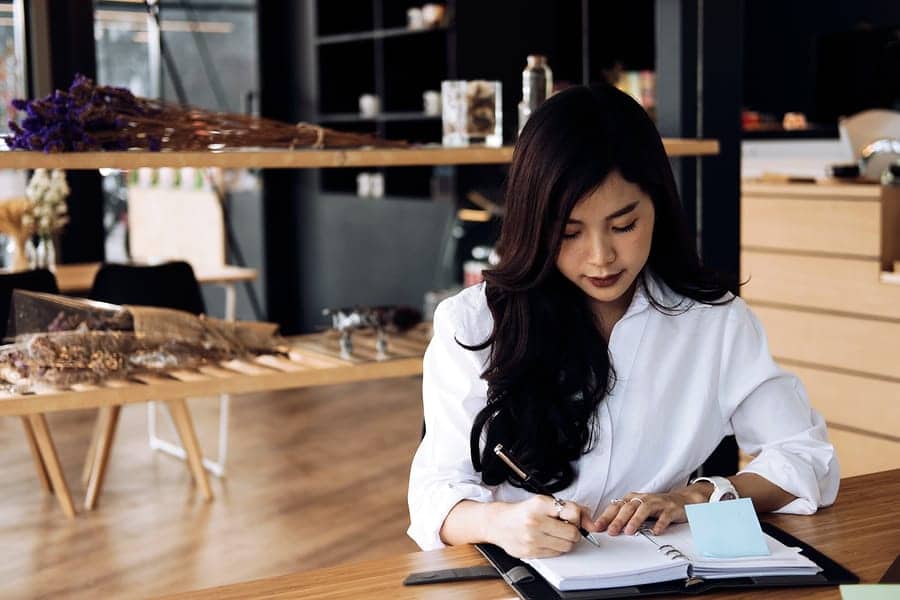 A photo of an entrepreneur making notes in her daily planner.