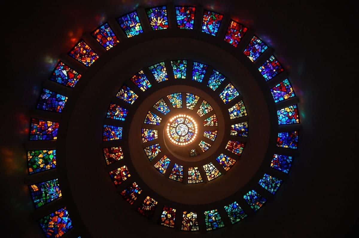 Multi-colored stained glass spiral ceiling.