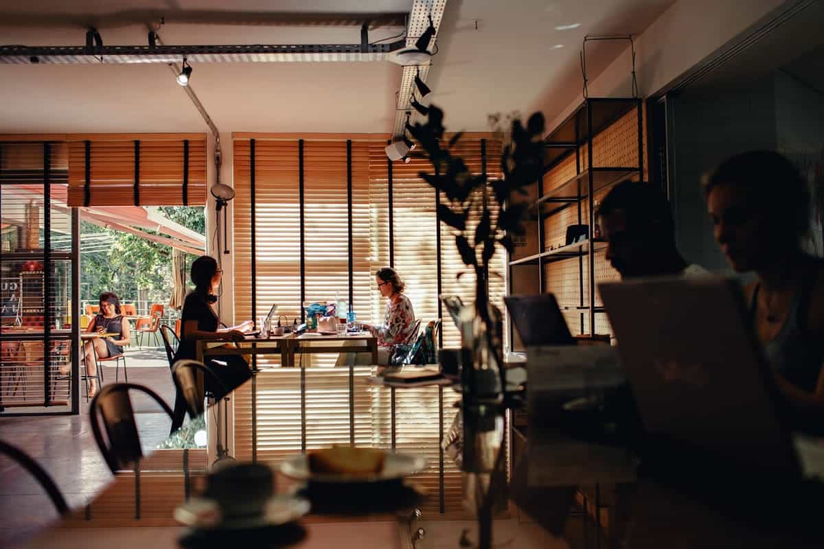 People working in a dark cafe.