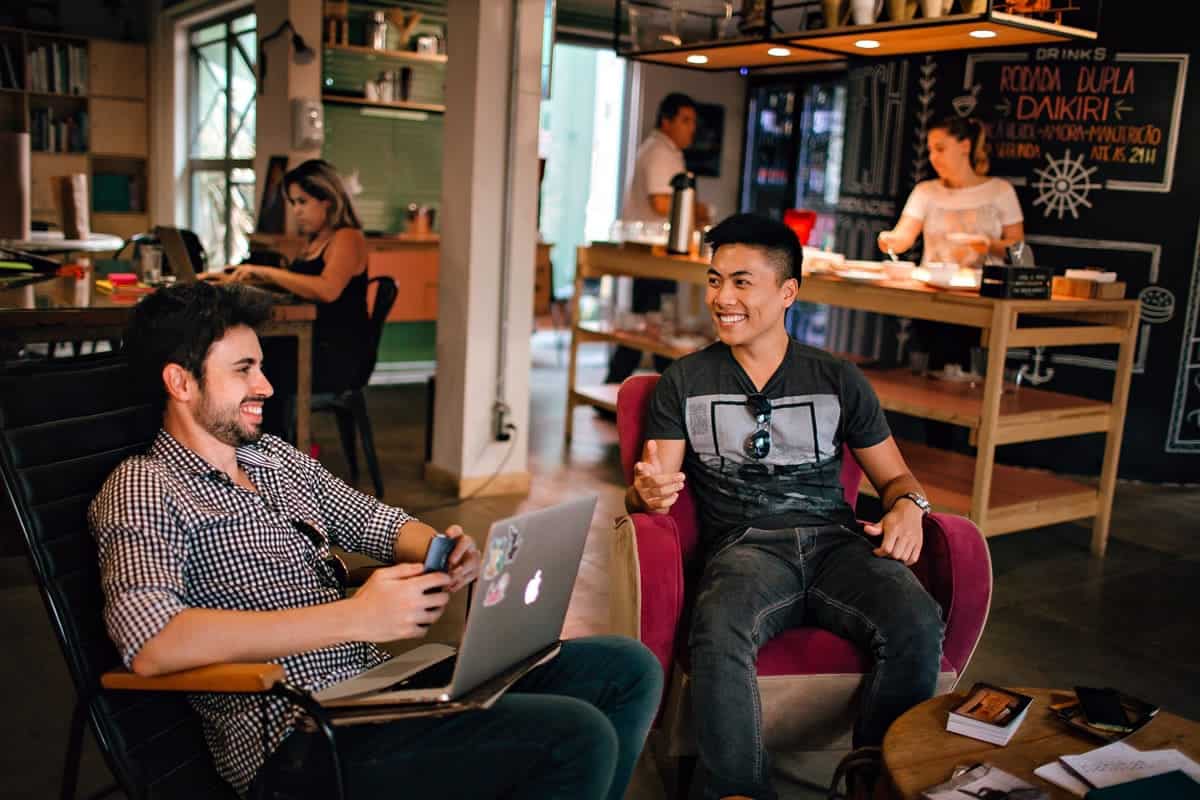 Two men meeting in a creative workspace.