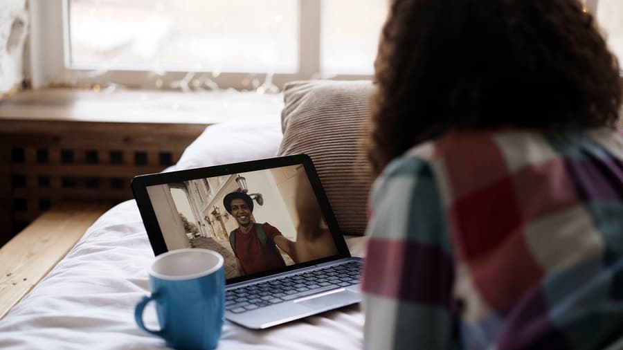 A photo of a woman having a video call with someone through her laptop.