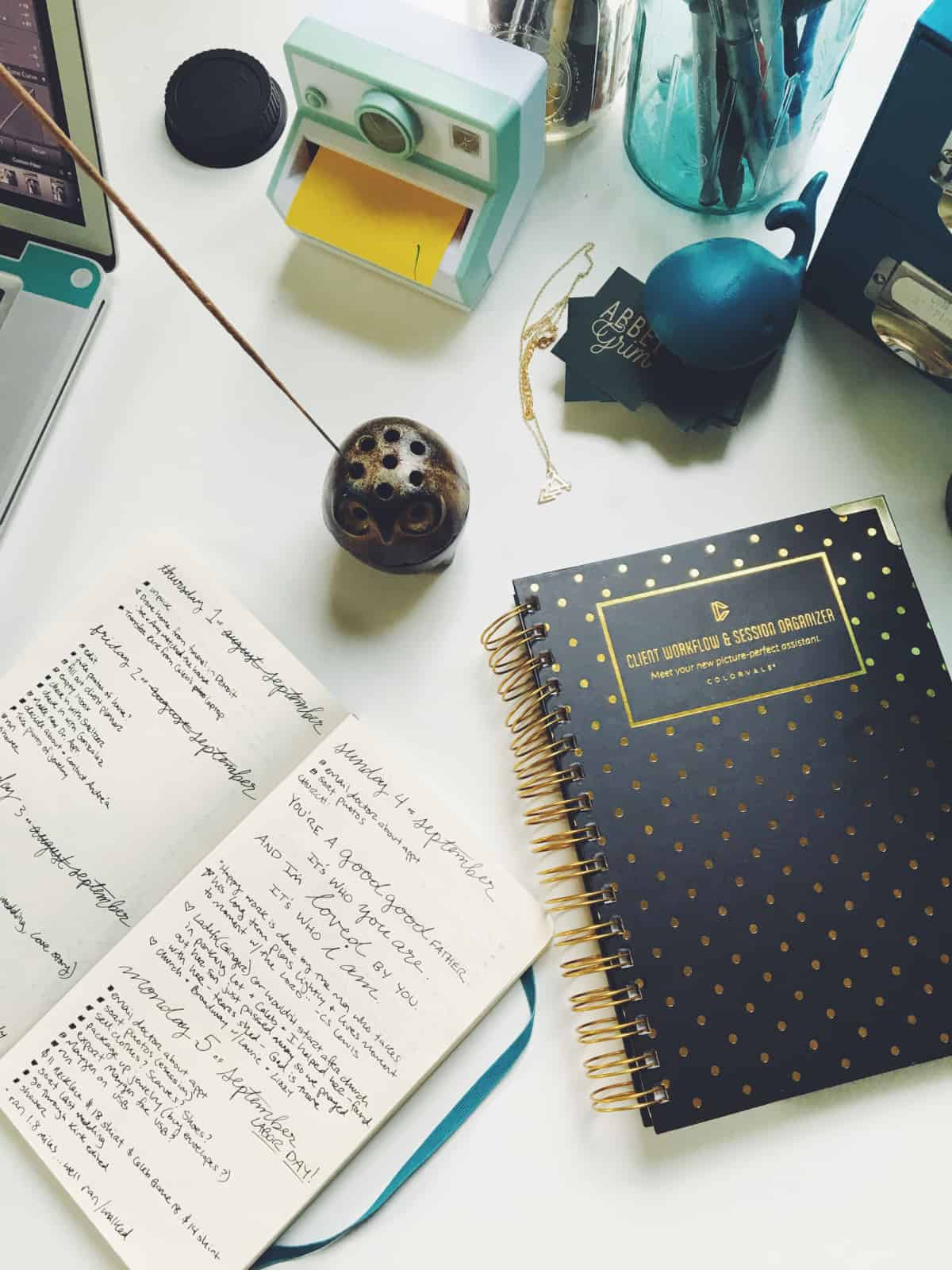 A photo of someone’s desk, complete with an organizer and a bullet journal.