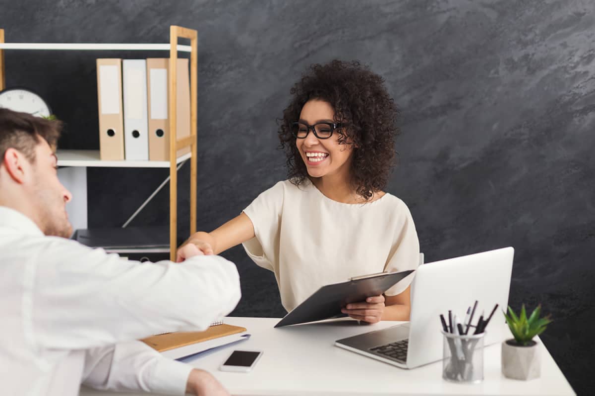 A photo of a woman meeting with a potential new hire candidate.