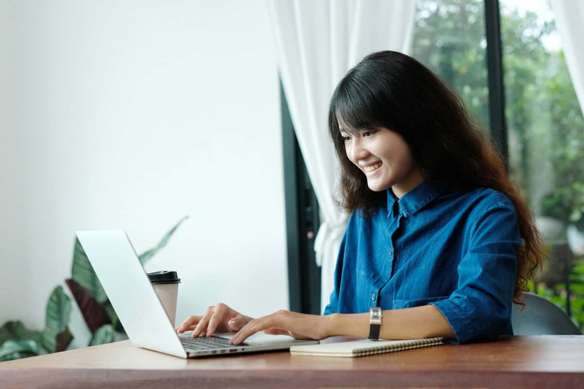 A photo of a young female product manager working in her home office.