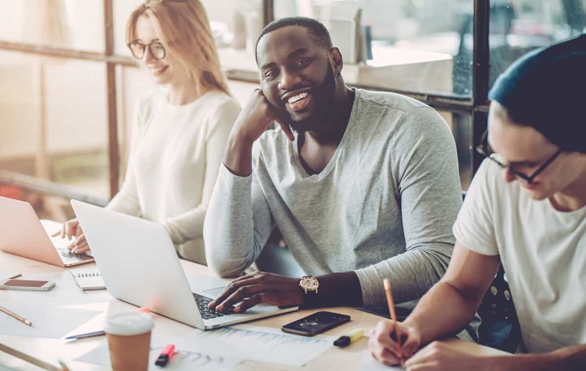 A photo of product managers having a productive meeting in a bright office.