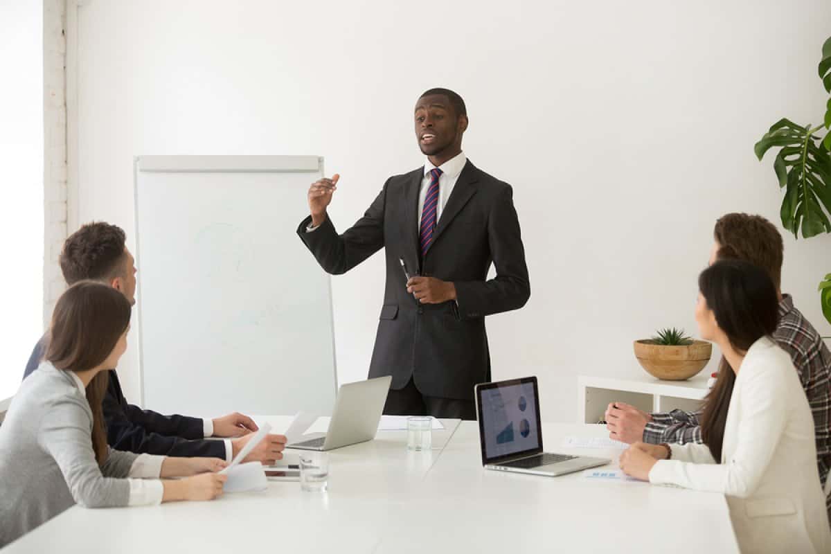 A photo of a man giving a presentation to potential investors.