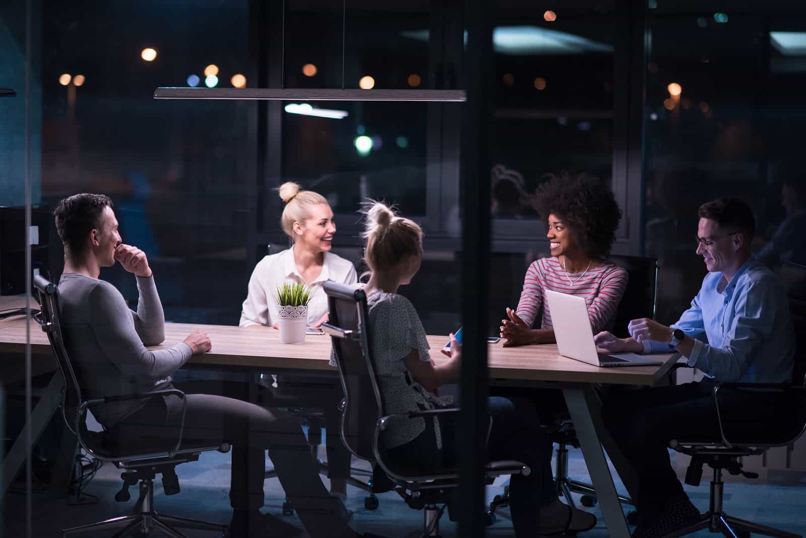 A photo of a mobile app development team having a late night meeting.