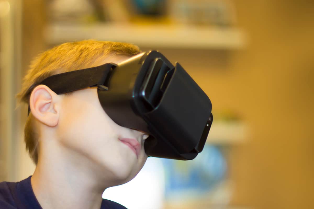 A photo of a young boy wearing a virtual reality headset.