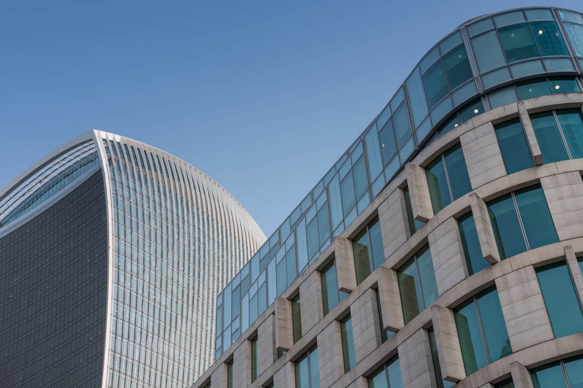 A photo of two buildings with postmodern design.