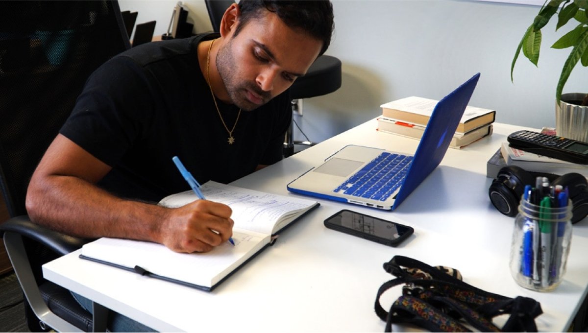  A photo of Fracture co-founder and CEO Abhi Lokesh working at his desk.