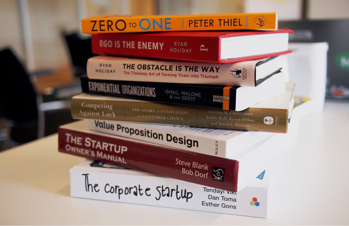  A photo of business books in a stack on someone’s desk.