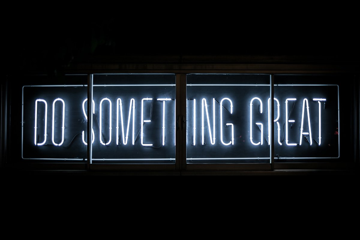 A photo of a neon sign that says “Do something great.”