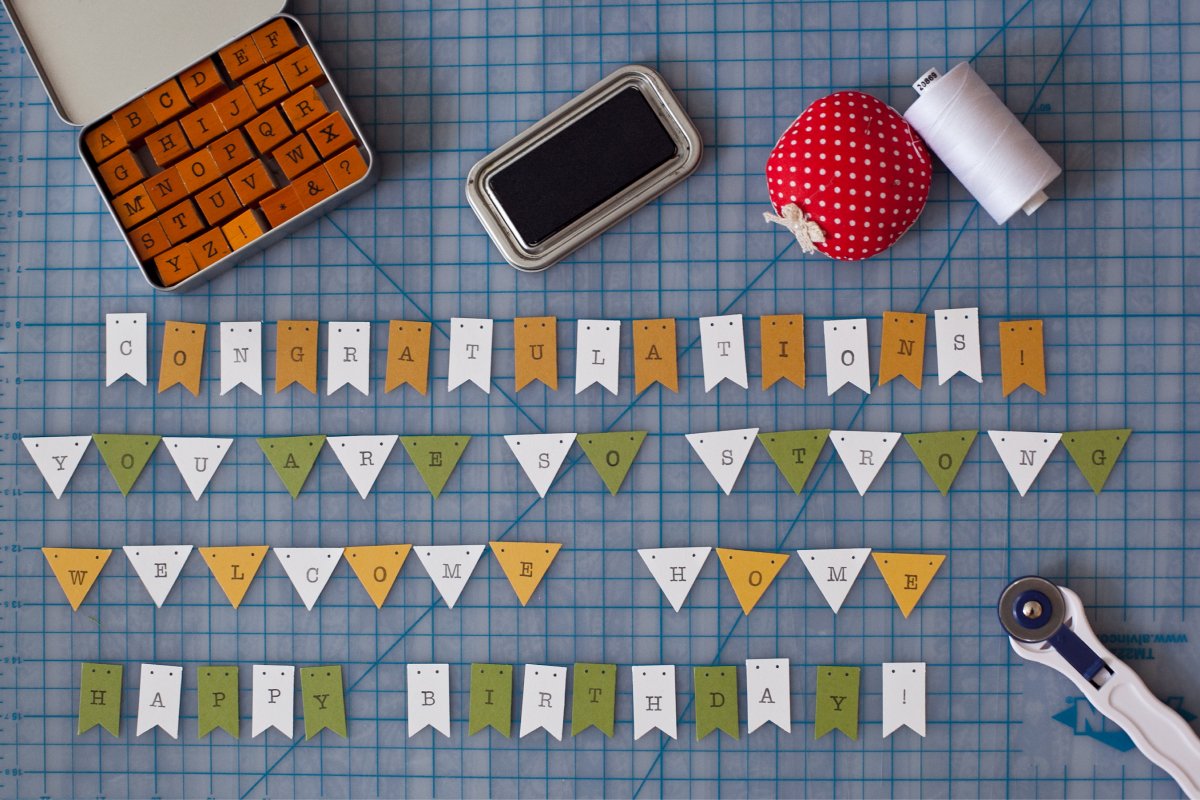 A photo of personalized buntings laid across a work surface.