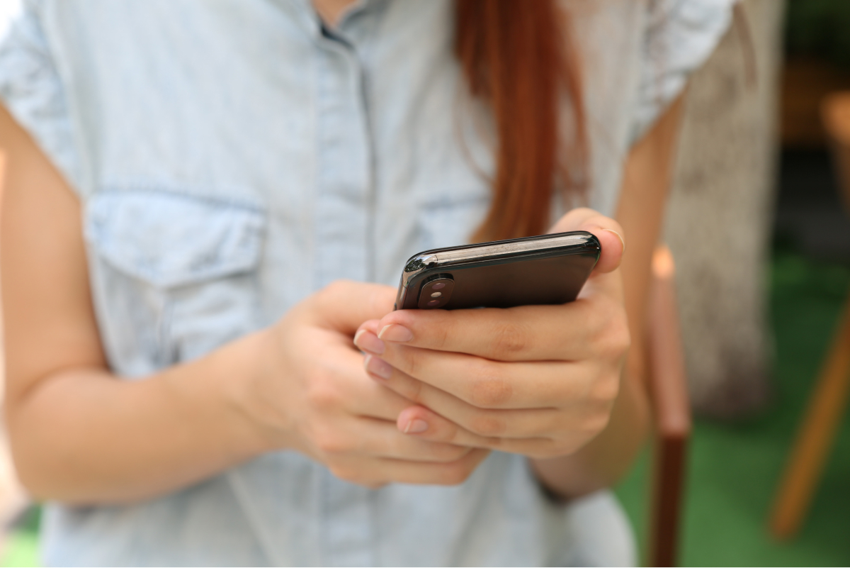 A close-up photo of a smartphone in someone’s hands.