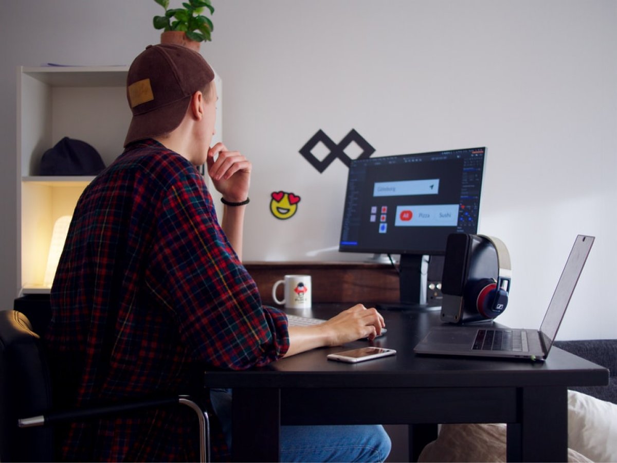 A UX designer works on his computer to design icons and other mobile interface elements.