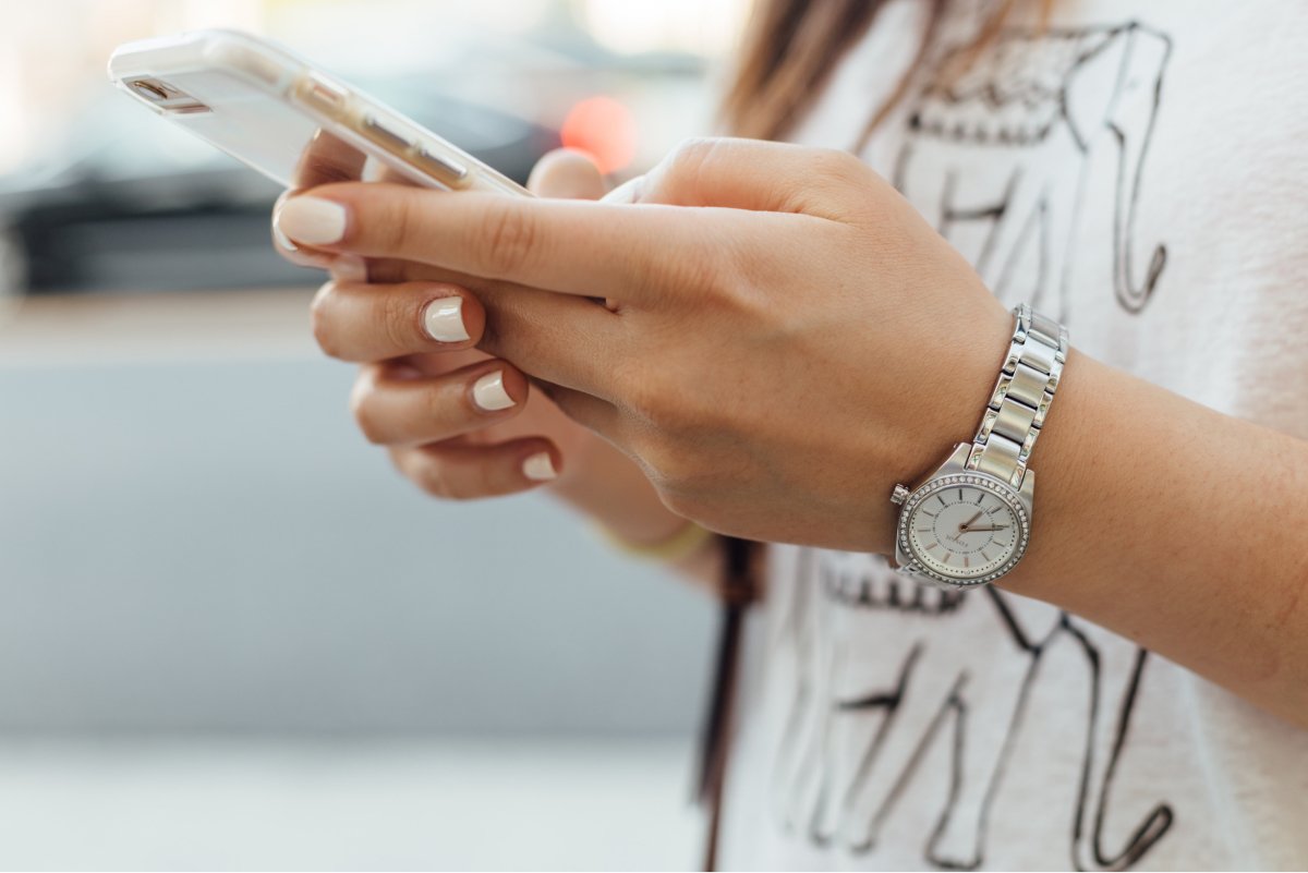 A close-up photo of someone holding a smartphone in their hands.