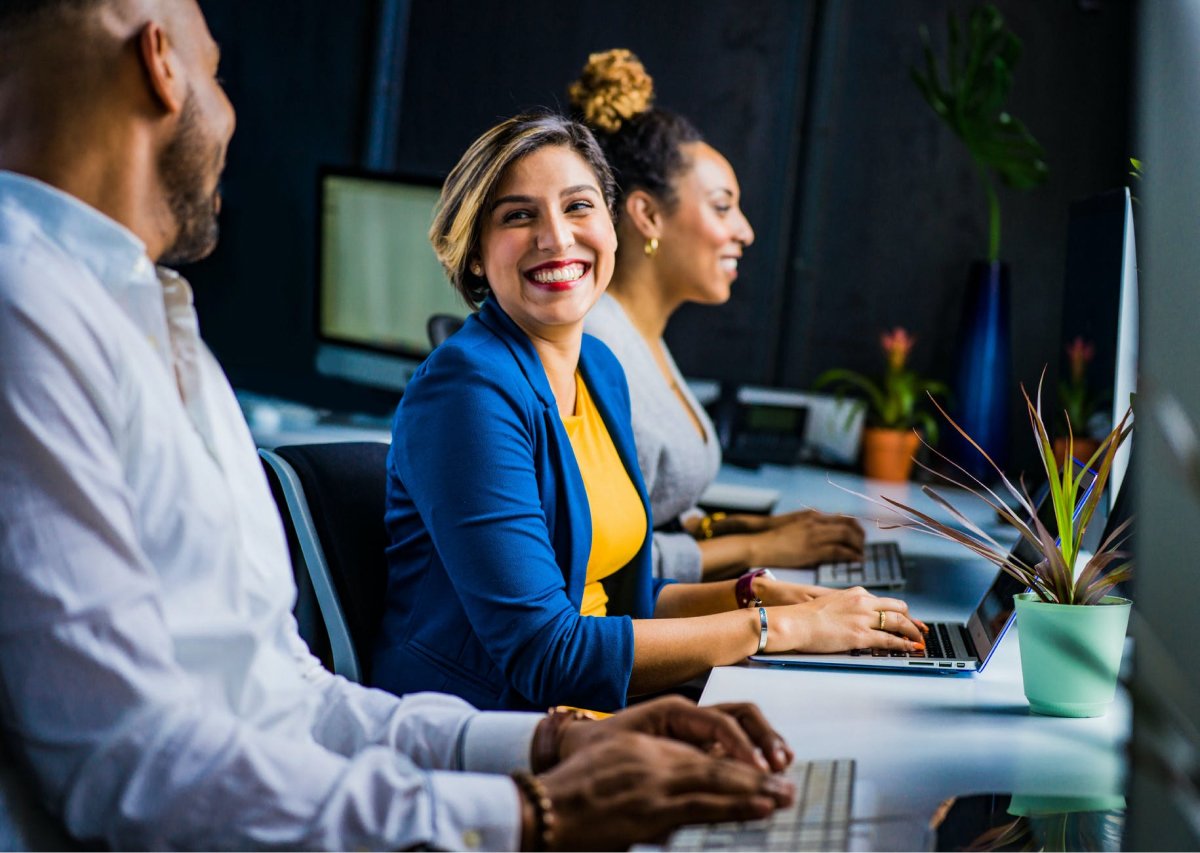 A woman smiling at her coworker. 