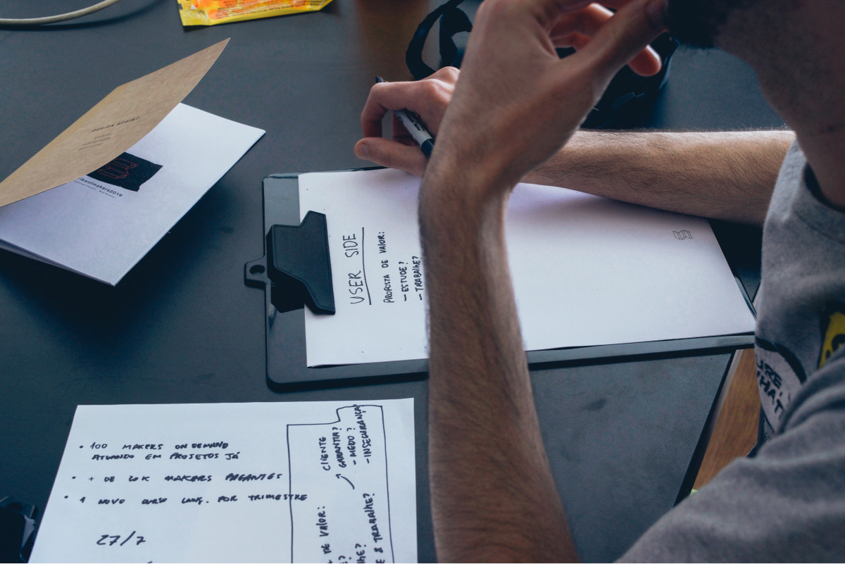  A man looking down at a clipboard.