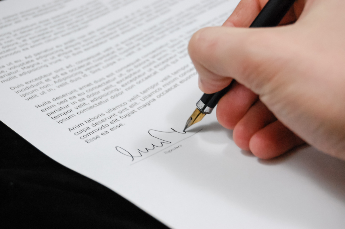 A person signing a contract. 